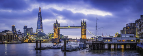 London Tower Bridge and The Shard illuminated over Thames panorama