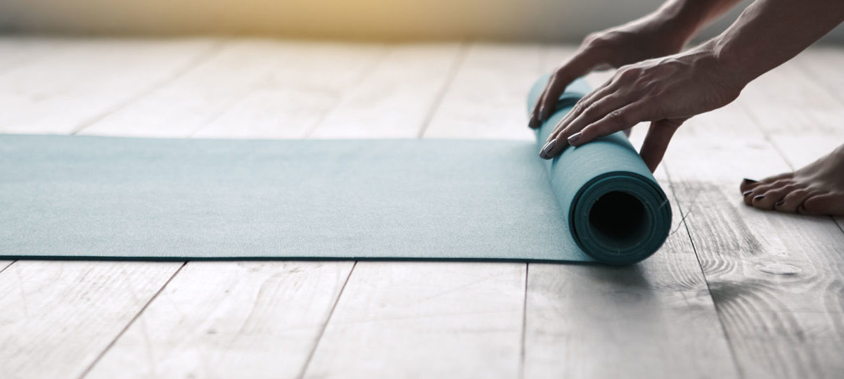 Photo of a yoga mat and a person